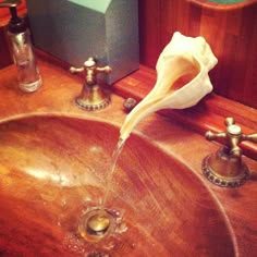 a bathroom sink with soap and water running from the faucet to the bowl