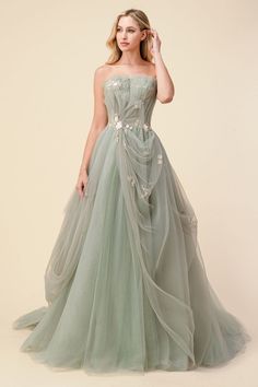 If you're a fan of Bridgerton, you'll be in the mood for spring garden hues like we are. This sage ballgown with delicate blossom details is made of beautifully draped plisse tulle that pleats over nude corset bodice. Whispery yet regal, plisse tulle at skirt has underlayers with subtle sparkle that make this gown truly magical. The bodice has an adjustable corset back for a guaranteed for all body types. Strapless tulle dress with A-line skirt with sweep train and open back. Hogwarts Yule Ball Dresses, Sage Green Wedding Dress, Yule Ball Outfits, Modest Prom Gowns, Green Wedding Dress, Andrea And Leo, Tulle Bridesmaid, Princess Fashion, Yule Ball