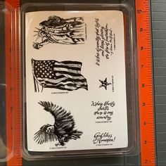 an american flag and eagle sticker sheet in a clear plastic container on a ruler