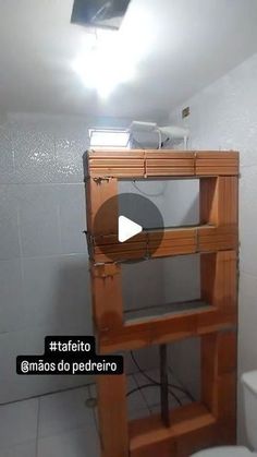 a bathroom with a toilet and a wooden shelf