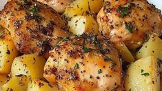 chicken and potatoes with herbs in a white bowl