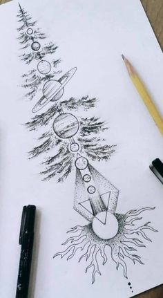 a pencil drawing of a christmas tree with planets and stars on it, next to a marker pen