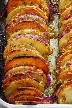 potatoes and onions in a baking dish with seasoning sprinkled on the side