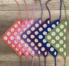 four crocheted bags with flowers on them