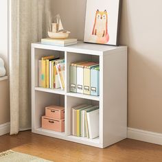 a white book shelf with books on top of it