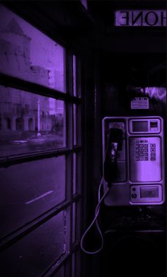 an old fashioned pay phone in front of a window