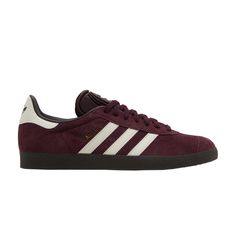 Find ADIDAS Gazelle 'maroon Gum on Editorialist. The adidas Gazelle ‘Maroon Gum’ showcases a simple two-tone palette on a classic silhouette that dates back to 1966. Built with suede in a dark burgundy hue, the upper features contrasting white leather on the signature three-stripes and Trefoil-branded back tab. A tonal suede overlay reinforces the toe, while synthetic suede lines the low-cut padded collar. The sneaker is mounted on a low-profile gum rubber cupsole, featuring a hexagonal traction pattern underfoot. Casual Burgundy Sneakers With Contrast Sole, Sporty Burgundy Sneakers With Boost Midsole, Classic Burgundy Sneakers With Round Toe, Classic Burgundy Round Toe Sneakers, Sporty Burgundy Sneakers With Rubber Sole, Burgundy Gazelle, Adidas Gazelle Burgundy, Maroon Adidas Gazelle, Burgundy Low-top Sneakers With Red Sole