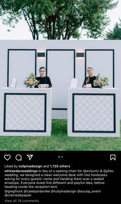 two people sitting at a reception table in front of a white wall with black trim