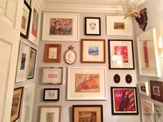 there are many framed pictures on the wall