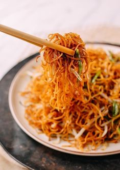 a white plate topped with noodles and carrots