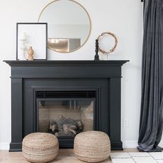 a living room with a fire place and ottomans