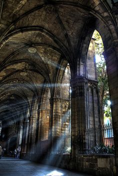 the sun shines through an old cathedral in black and white, as it casts long shadows on the wall