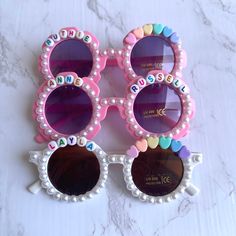 Introducing our kids custom sunglasses, personalized with child's name. These made-to-order flower sunglasses make the perfect gift for every little girl in your life. Perfect as birthday gift, events, party favors, baby showers, and more! These specific sunglasses come personalized with child's name in colorful letters, rainbow heart charms, and adorned with petal accents. If your child has a double name, it will replace heart charms. *these sunglasses for most kids ages 2-10 years old. Caution: choking hazard, contains small parts. Adult supervision recommended Decorate Sunglasses, Sunglasses Craft, Birthday Sunglasses, Diy Sunglasses, Beaded Sunglasses, Girl Sunglasses, Stacked Beaded Bracelets, Double Name, Last Minute Birthday Gifts