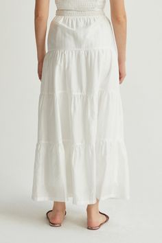 Made with a delicate Tencel-blend, the Daisy Tiered Maxi Skirt is high-waisted with a side hook & eye and invisible zipper closure, partial smocked waist at back, and tiered skirt detail. Style it with the matching Manny Shirred Crop Top. High waisted Side hidden zipper closure Back partial smocked waist detail Tiered skirt Lined Hand wash Imported Self: 85% Tencel, 15% Polyester Lining: 98% Polyester, 2% Spandex Style No. CS9185 Model is wearing size S Model InfoHeight: 5'6" I Bust: 32” I Waist Brunch Ruffle Hem Tiered Maxi Skirt, Tiered Gathered Skirt For Brunch, Cotton Tiered Skirt For Daywear, Tiered Lined Maxi Skirt For Brunch, Lined Tiered Maxi Skirt For Brunch, Flowy Tiered Skirt For Brunch, Relaxed Tiered Skirt For Brunch, Voluminous Skirt For Daywear, Tiered Ruffled Skirt Bottoms For Vacation