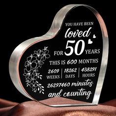 a heart shaped glass plaque that says you have been loved for 50 years