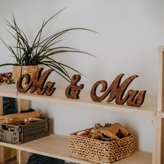 two wooden signs that say mr and mrs on them next to a basket full of wood chips