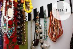 there are many different necklaces hanging on the wall next to each other with text overlay that says tier 2