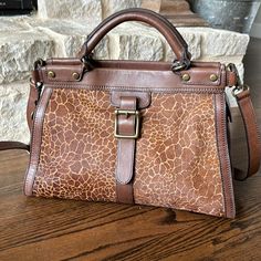 Beautiful Fossil Vintage Revival Satchel Giraffe Print. Large Zipper To Closure Opens To Interior With Zippered Pocket & Two Pockets 11.5"H 16"W 6d Top Handles Drop 3" Shoulder Strap 20" Condition Is Like New Aside From One Small Flaw That Was There When Purchased New. On The Side With The Buckle, There Is A Very Small Area Where There Is No Hair See Last Photo For Close Up. Only Used Once And Has Been In The Dust Bag Ever Since. Dust Bag Included! Comes From Smoke Free Home. Fossil Bags, Vintage Revival, Giraffe Print, Fossil, Dust Bag, Satchel, Shoulder Strap, Buckle, Bag Lady