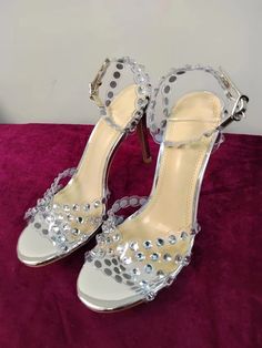 Elevate your party look with our Sparkling Rhinestone Stiletto Heeled Sandals. The perfect combination of style and comfort, featuring sparkling rhinestones and a stiletto heel. Make a statement and shine all night long. Color : Silver Type : Ankle Strap Style : Glamorous Toe : Open Toe Pattern Type : Plain Details : Rhinestone Strap Type : Ankle Strap Heels : Stiletto Heel Height : High Heel Upper Material : PVC Lining Material : PVC Insole Material : Microfiber Leather Outsole Material : Polyurethane Rhinestone Ankle Strap Heels For Party Season, Party Season Heels With Rhinestones And Ankle Strap, Rhinestone Heels With Ankle Strap For Party Season, Cocktail Heels With Rhinestones And Ankle Strap, Party Sandals With Rhinestone Rivets And Round Toe, Crystal Ankle Strap Heels For Evening, Bedazzled Round Toe Heels For Summer, Bedazzled Round Toe Summer Heels, Summer Bedazzled Heels With Round Toe