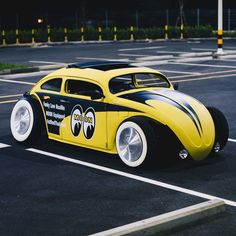 a yellow and black car parked in a parking lot