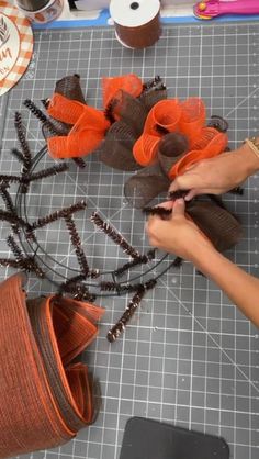 someone is working on some crafting supplies with scissors and yarns in the shape of flowers