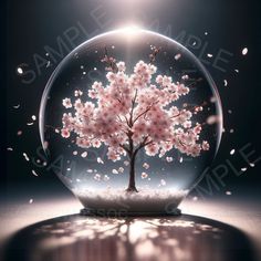 a snow globe with a cherry blossom tree inside