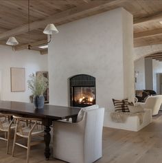 a dining room table with chairs and a fire place