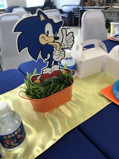 a blue table topped with a bowl of green plants