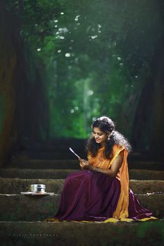 a woman sitting on steps in the woods