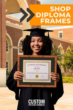 a woman holding up a diploma certificate in front of a building with an orange arrow