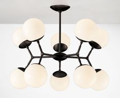 a black and white chandelier with eight globes hanging from it's center