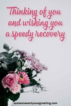 a vase filled with pink and white flowers next to a sign that says thinking of you and wishing you a speedy recovery