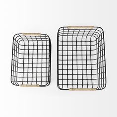 two black wire baskets sitting on top of a white wall next to eachother