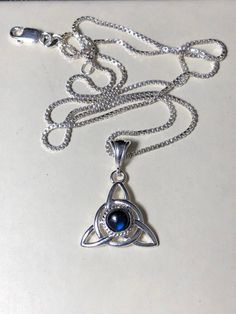 Did you enjoy Charmed, the TV show? I'll fabricate this sterling silver Celtic Trinity Knot pendant, approximately 1 inch in diameter, and I will set your choice of a 6mm round faceted or cabochon gemstone from the drop down menu. This comes with a 16 inch sterling silver box chain at 1.2mm thickness with a lobster claw for secure attachment. This is shown with a classic green Lab emerald faceted gemstone for the lucky lass in you! It's lovely, graceful and elegant...a timeless and classic tradi Spiritual Sterling Silver Jewelry For May Birthstone, Mystical Sterling Silver Necklace In Silver, Mystical Sterling Silver Necklace For Gift, Spiritual Hallmarked Sterling Silver Necklaces, Mystical Sterling Silver Necklace, Spiritual Sterling Silver Hallmarked Necklace, Sterling Silver Amulet Jewelry With Gemstone, Handmade Sterling Silver Necklace With May Birthstone, Silver May Birthstone Round Pendant Jewelry