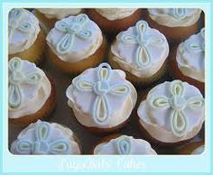 cupcakes decorated with white frosting and blue icing are arranged in rows