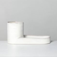 two rolls of toilet paper sitting on top of a white table next to each other