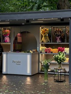 a flower shop with flowers on display in the window