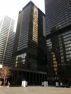 the tall buildings have many windows on each floor and are surrounded by other skyscrapers