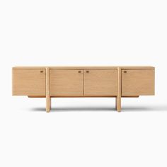 the sideboard is made from wood and has three drawers, one with two doors