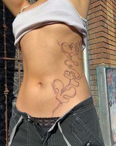 a woman's stomach with tattoos on it