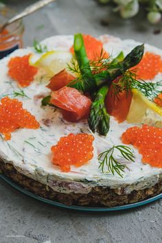 a cake with salmon and cavias on it