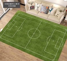 a living room with a soccer field rug on the floor