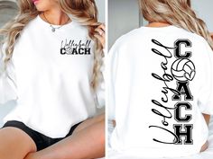 a woman sitting on top of a bed wearing a white shirt with the word coach printed on it