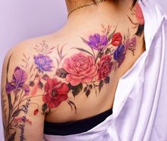 a woman's back with flowers on it