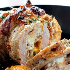 a close up of meat in a pan on a table with other food items and utensils