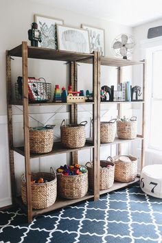 a shelf with baskets and toys on it