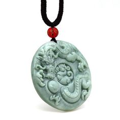 Jade Dragon Chasing the Flaming Pearl Pendant Necklace Many images of Chinese Dragons show a Flaming Pearl under their chin or in their claws. The Pearl is associated with Spiritual Energy, Wisdom, Prosperity, Power, Immortality, Thunder, and the Moon. Chinese Art often depicts a Pair of Dragons chasing or fighting over the Flaming Pearl. In the Chinese Culture, the Dragon represents Good Luck, Strength, Health and also the Male Element Yang. The Dragon is unique because it is the only Mythical Creature of all the Animals in the Chinese Zodiac and more babies are born in the Year of the Dragon than any other Zodiac Animal. The Dragon King, also known as the Dragon God, is a Figure from Chinese Mythology. The transliteration of his name in Chinese is Longwang. He has authority over the stor Adjustable Carved Amulet Style Necklaces, Carved Pendant Necklace Collectible, Collectible Carved Pendant Necklace, Adjustable Dragon Design Necklace As A Gift, Adjustable Dragon Design Necklace For Gift, Carved Round Necklace For Gift, Carved Round Necklace Gift, Adjustable Carved Round Necklaces, Adjustable Round Carved Necklaces