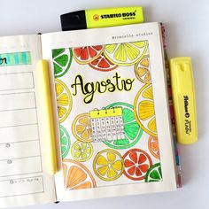 an open notebook with the word agroste written in it and some markers on top