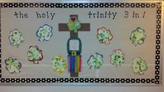 a bulletin board with shamrocks and a crucifix in the center for children to use