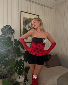 a woman in a ladybug costume posing for the camera with her hands on her hips